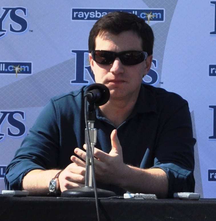 Head-and-shoulders photo of Andrew Friedman speaking at a press conference.