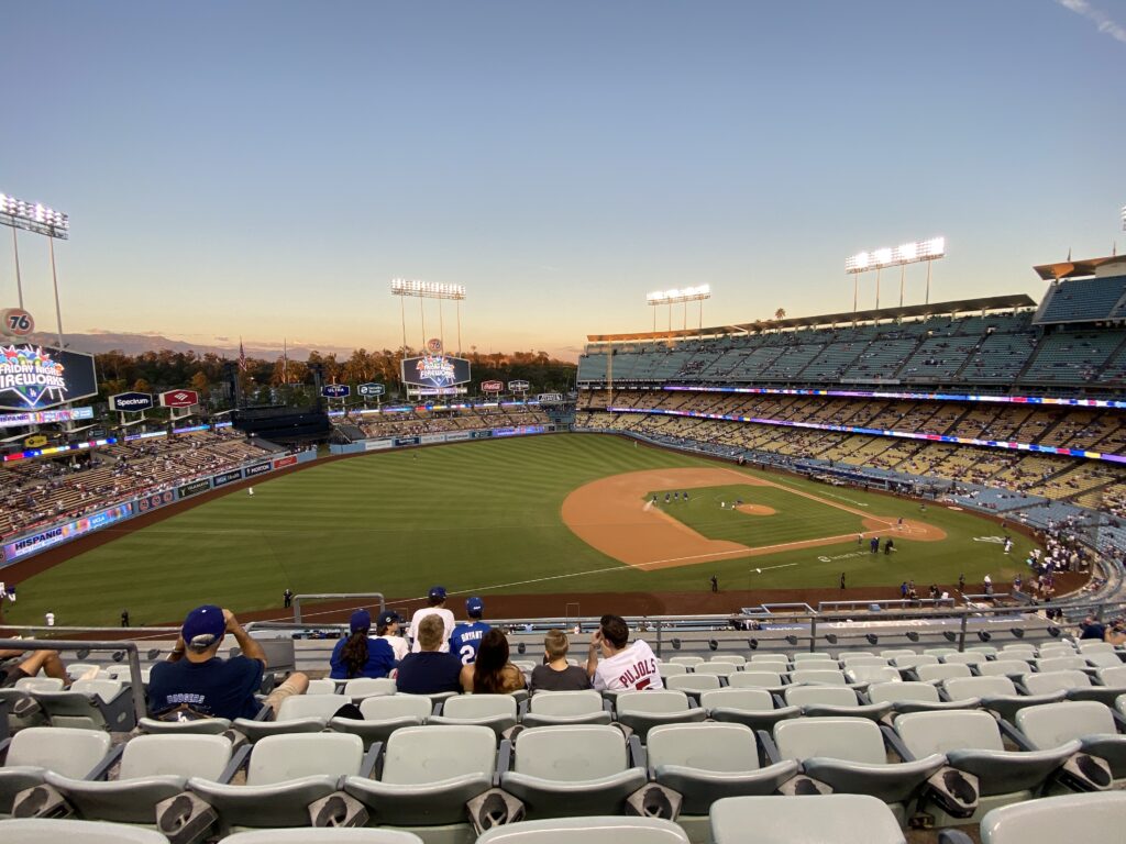 Sunset view from the upper level at Dodger Stadium before a game, with video boards advertising Friday Night Fireworks.